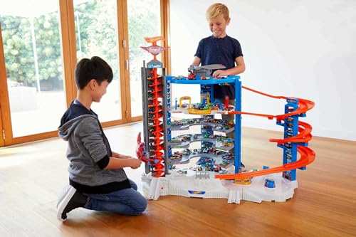 Hot Wheels Toy Car Track Set & 4 1:64 Scale Cars, Super Ultimate Garage, 3+ ft Tall with Motorized Gorilla & Storage for 140 Cars (Amazon Exclusive)
